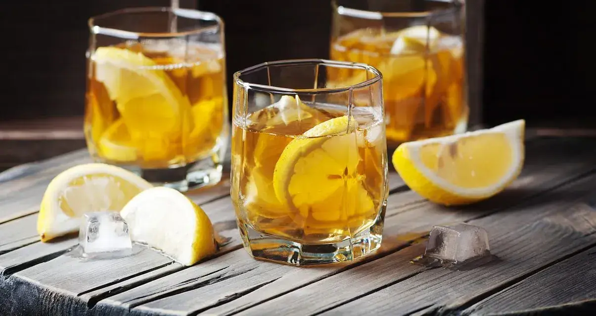 Trzy szklanki z bursztynowym napojem i plasterkami cytryny. Czy to metaxa, co to za drink?