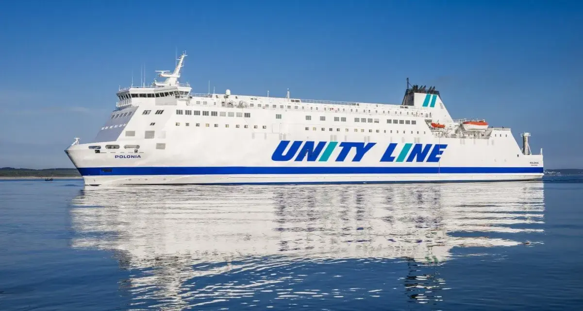 Biały prom Unity Line "Polonia" płynie po spokojnym, błękitnym morzu.