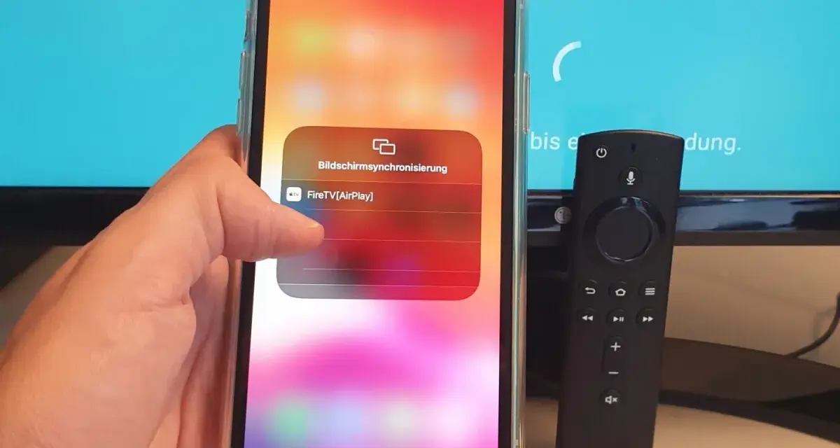 iPhone mit Fire TV Stick verbinden: AirPlay-Option wird auf dem iPhone angezeigt, daneben liegt die Fire TV Fernbedienung.