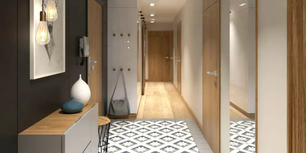 Un corridoio stretto con un tappeto geometrico, mobili moderni e un quadro astratto. Idee per un corridoio che unisce funzionalità ed estetica.