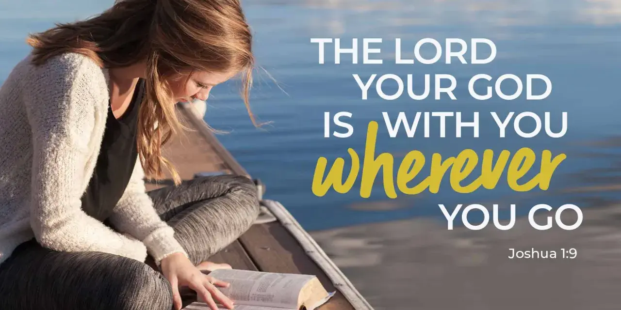 A young woman reads her Bible by the water, finding comfort in trusting God in difficult times with verses like Joshua 1:9.