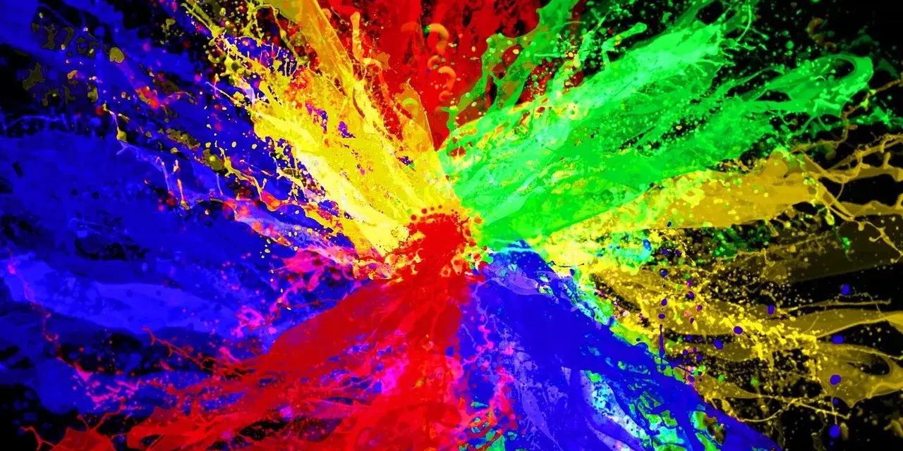 Eksplozja kolorów: czerwony, zielony i niebieski tworzą dynamiczną paletę kolorów RGB na czarnym tle.