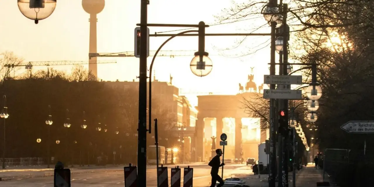 A lone runner passes the Brandenburg Gate at sunrise. This iconic Berlin landmark is a must-see, no matter how many days in Berlin you have.