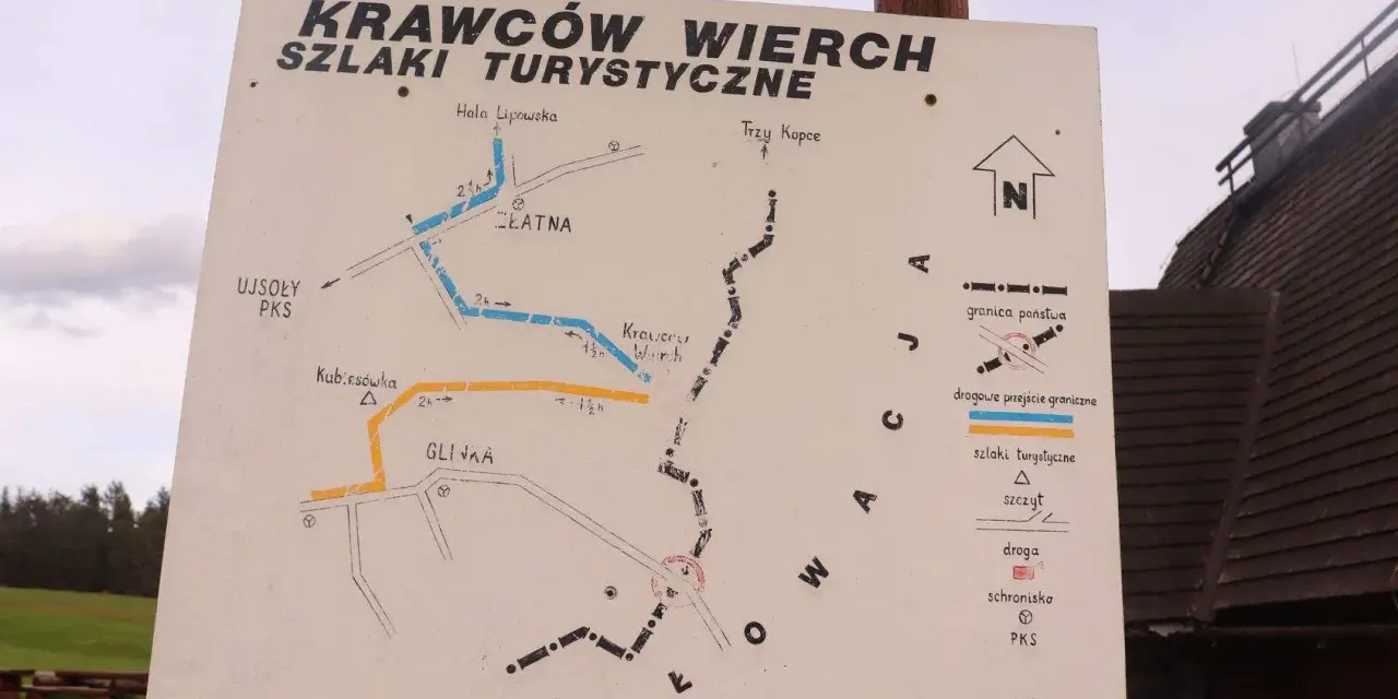Mapa szlaków turystycznych na Krawców Wierch. Widać szlaki niebieskie, żółte i czarne, punkty PKS, schroniska i przejścia graniczne.