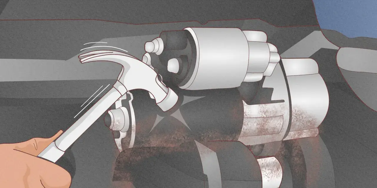 A hand uses a hammer to tap a car's starter motor, a common trick for how to start a car with a bad starter.