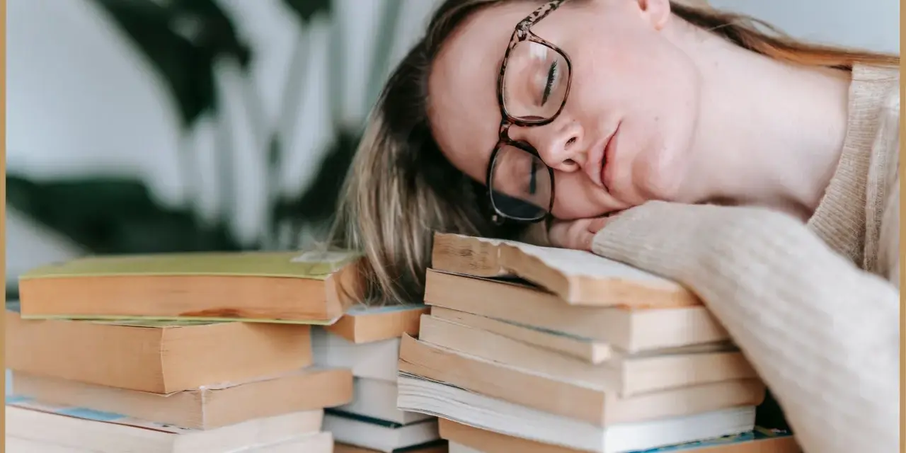 Zmęczona studentka zasnęła na stosie książek, zastanawiając się, psychoza co to.