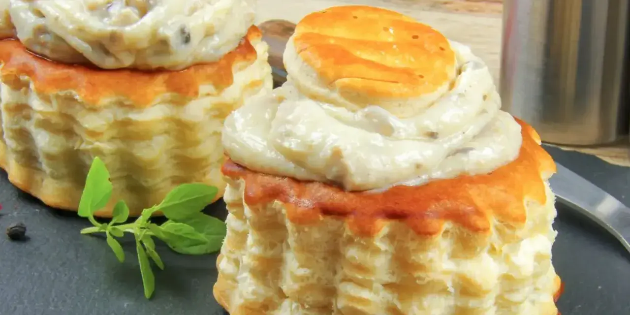 Deux bouchées à la reine garnies d'une sauce crémeuse aux champignons. La différence vol au vent et bouchée à la reine est subtile, mais ces délices sont irrésistibles.