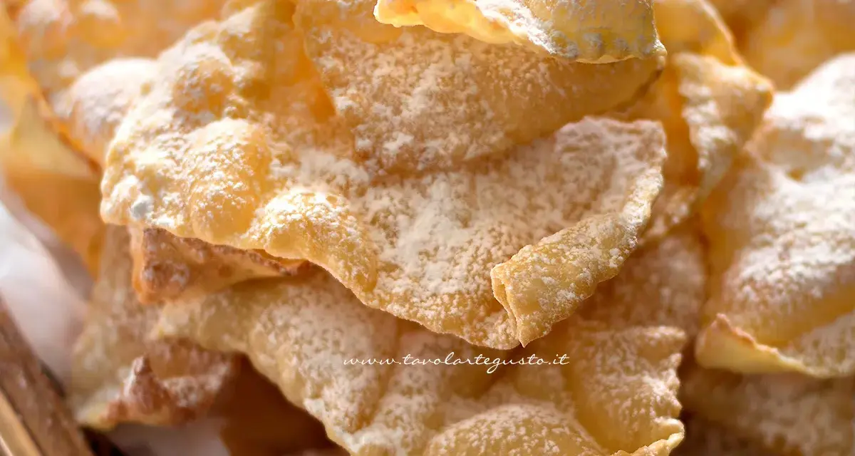 Chiacchiere croccanti, dolci e leggere, come quelle della ricetta della nonna, cosparse di zucchero a velo.
