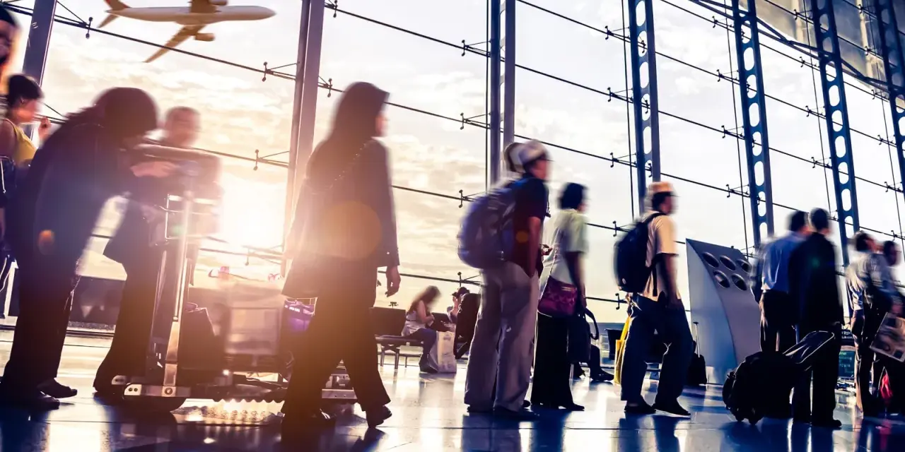 Persone in un aeroporto con un aereo in volo fuori dalla finestra. Probabilmente l'aeroporto più vicino a Venezia.