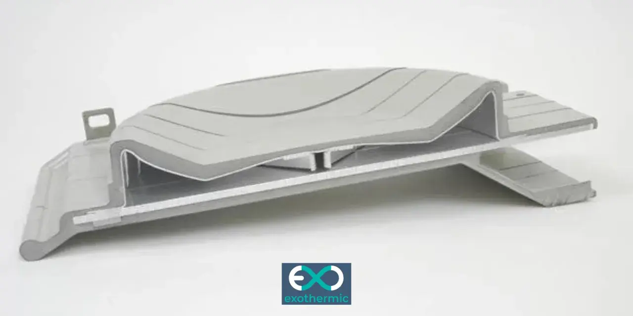 A complex, layered component showcasing advanced forming plastics, with a subtle wave pattern on the top surface.
