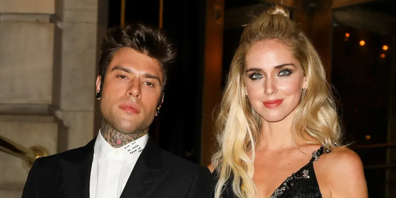 Chiara Ferragni i Fedez pozują do zdjęcia. Ona ma blond włosy upięte w kok, a on tatuaże na szyi.