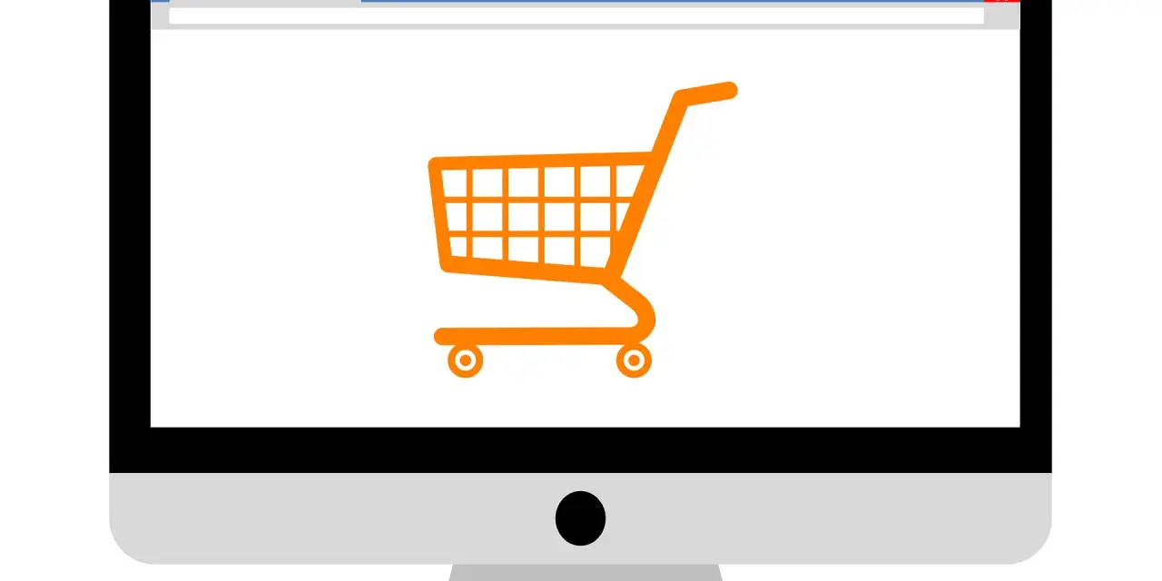 Monitor z ikoną koszyka zakupowego, symbolizujący branżę e-commerce i zakupy online.