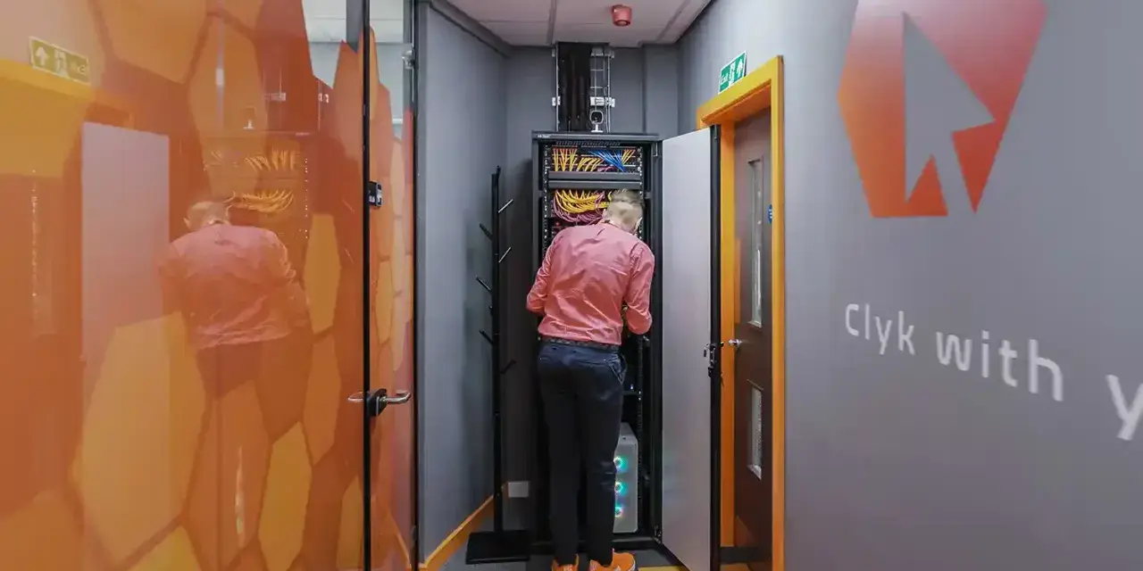 Technician working on network infrastructure services in a server room.