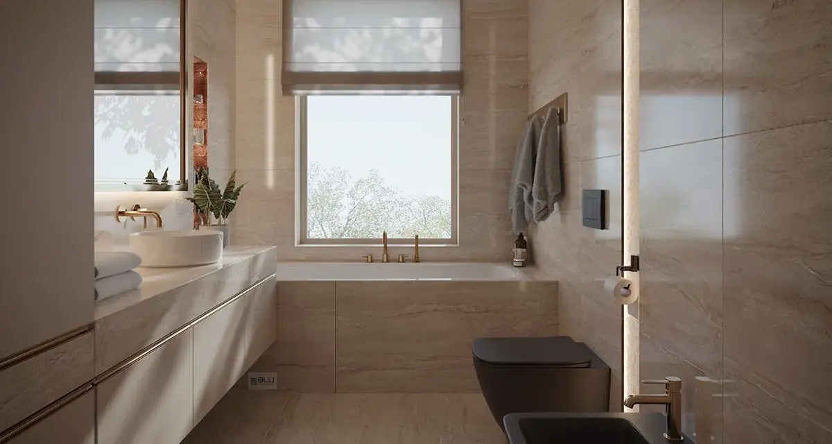 Nowoczesna łazienka z oknem na wprost drzwi, wanna, czarna miska WC i bidet, kamienne płytki, złote baterie.