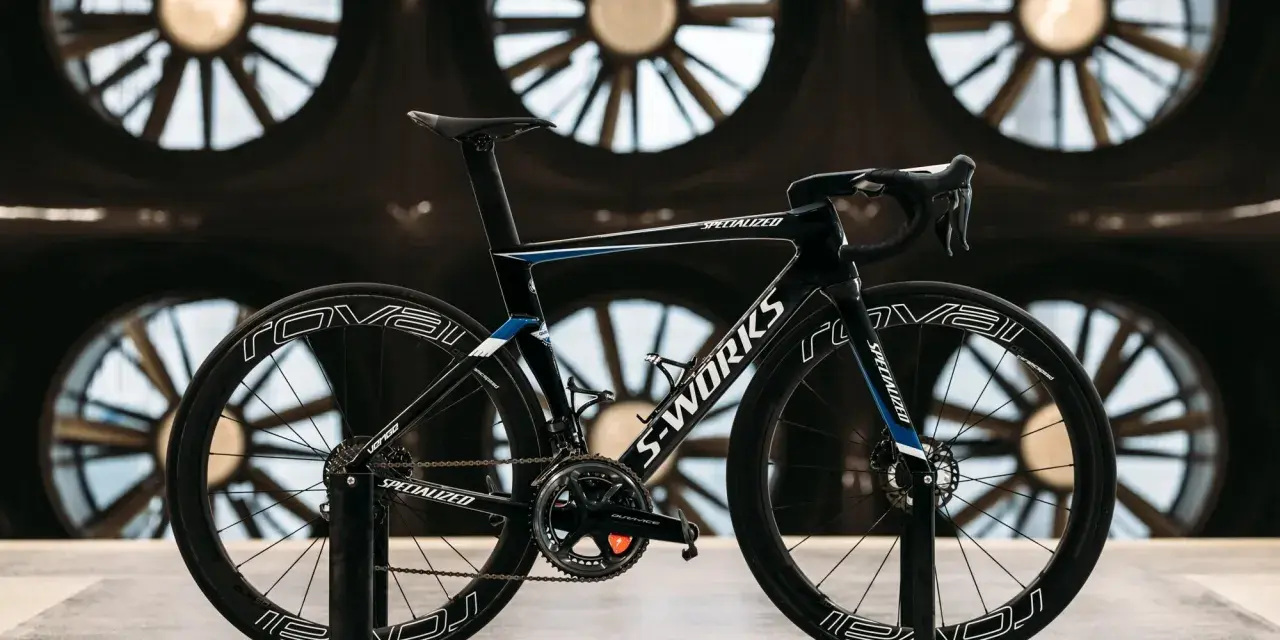 A black S-Works aero bike, designed for speed, is showcased in front of large industrial fans. This is what an aero bike looks like.
