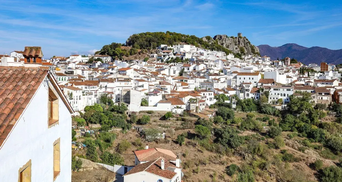 A picturesque white village cascades down a hillside, perfect for a southern Spain itinerary.