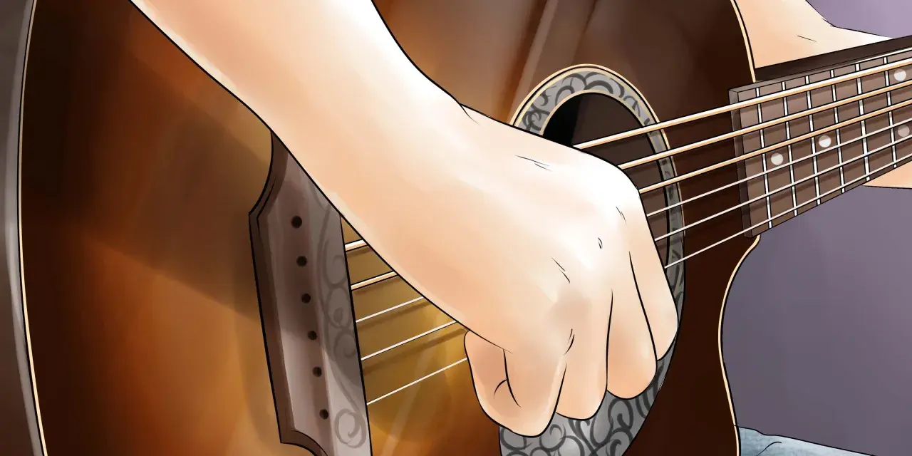 Eine Hand spielt auf einer Gitarre, vielleicht ein Geburtstagslied.