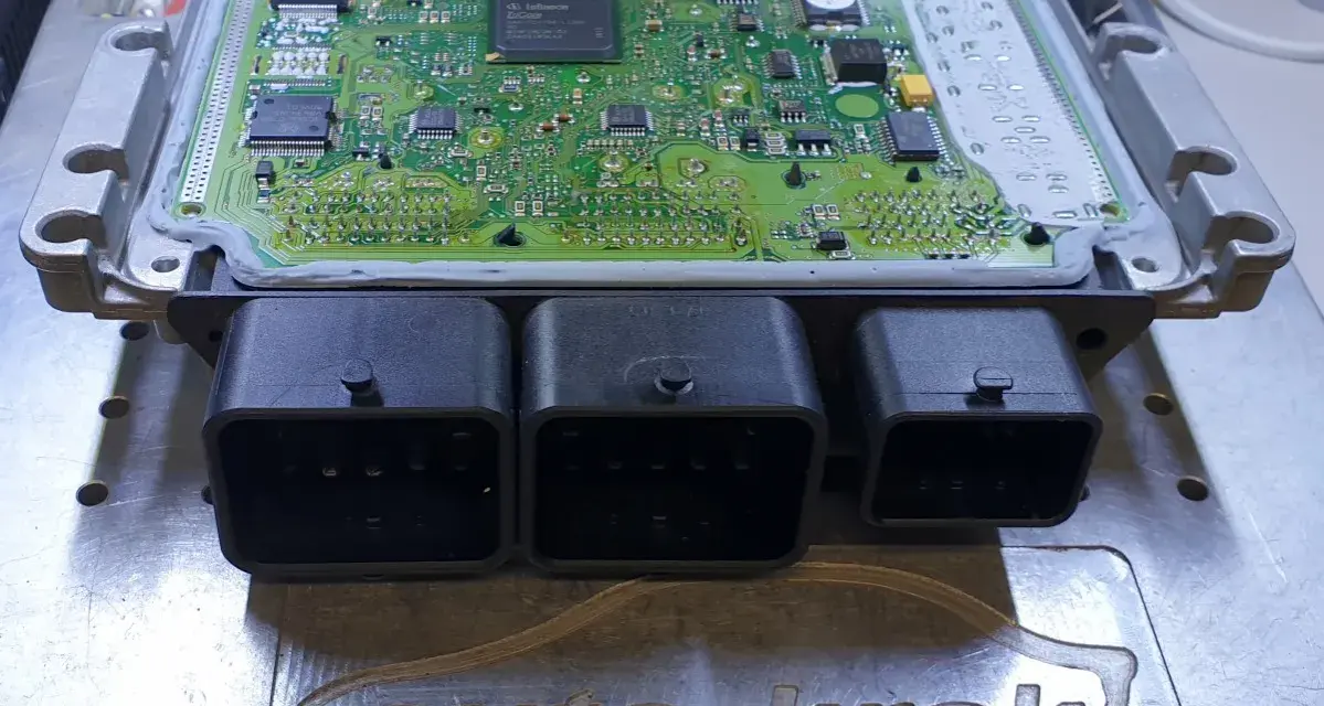 Elektronika silnika Citroen z widocznym błędem DTC P1336. Moduł ECU na stole warsztatowym.