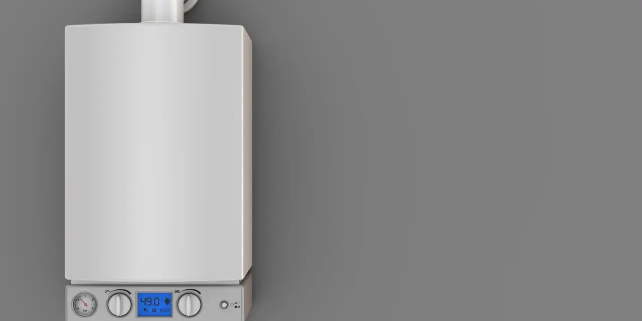 Caldaia moderna con display digitale e manometri. Il tubo scarico fumi caldaia normativa è visibile in alto, essenziale per la sicurezza.