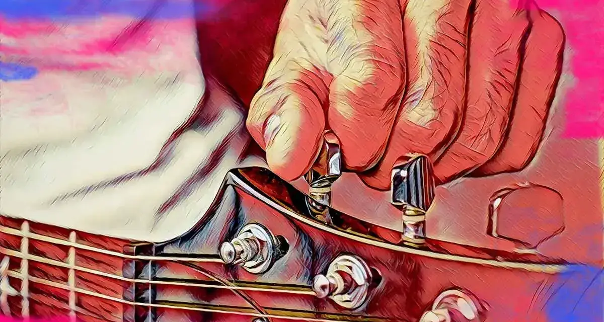 Dłoń stroi gitarę, naciągając struny do idealnego dźwięku a 440 hz.