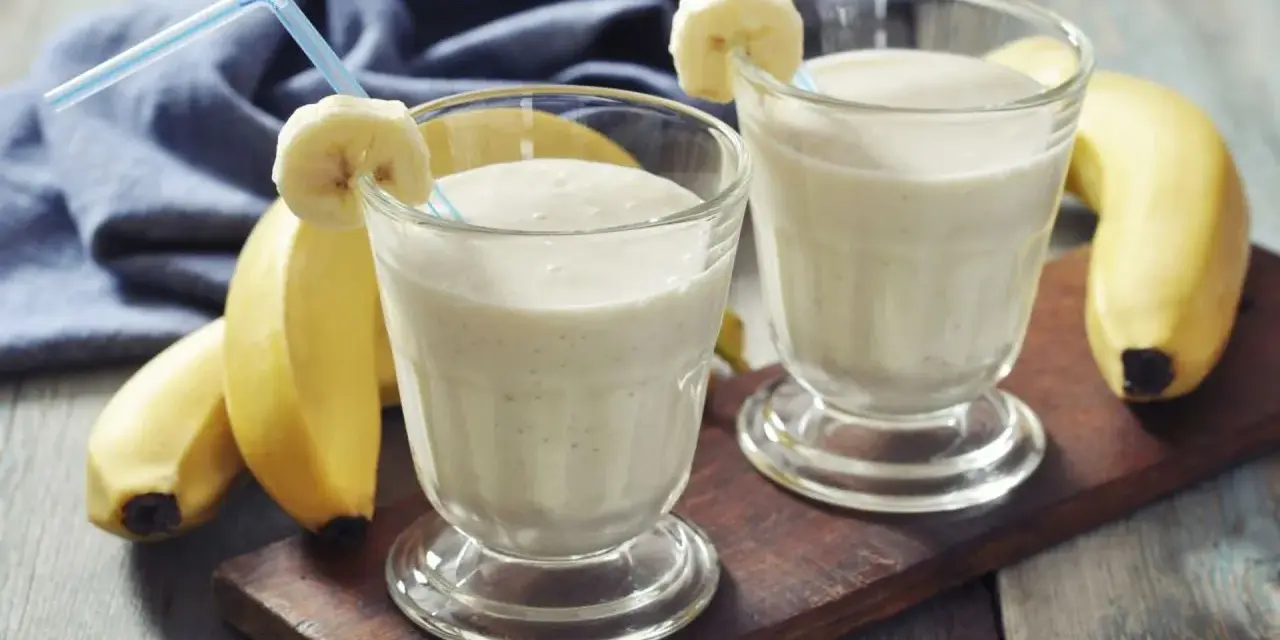 Dwa pyszne szejki proteinowe z bananem, gotowe do wypicia. Idealne po treningu!