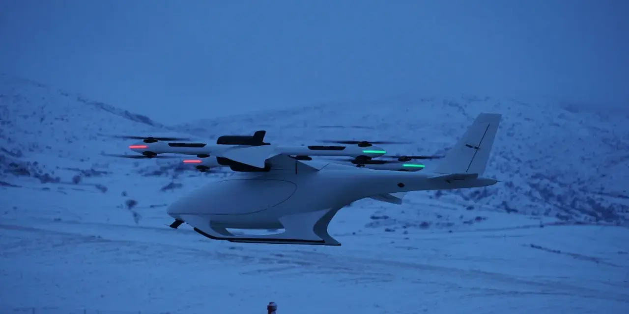 A white vtol drone with red and green lights flies over a snowy landscape at dusk.