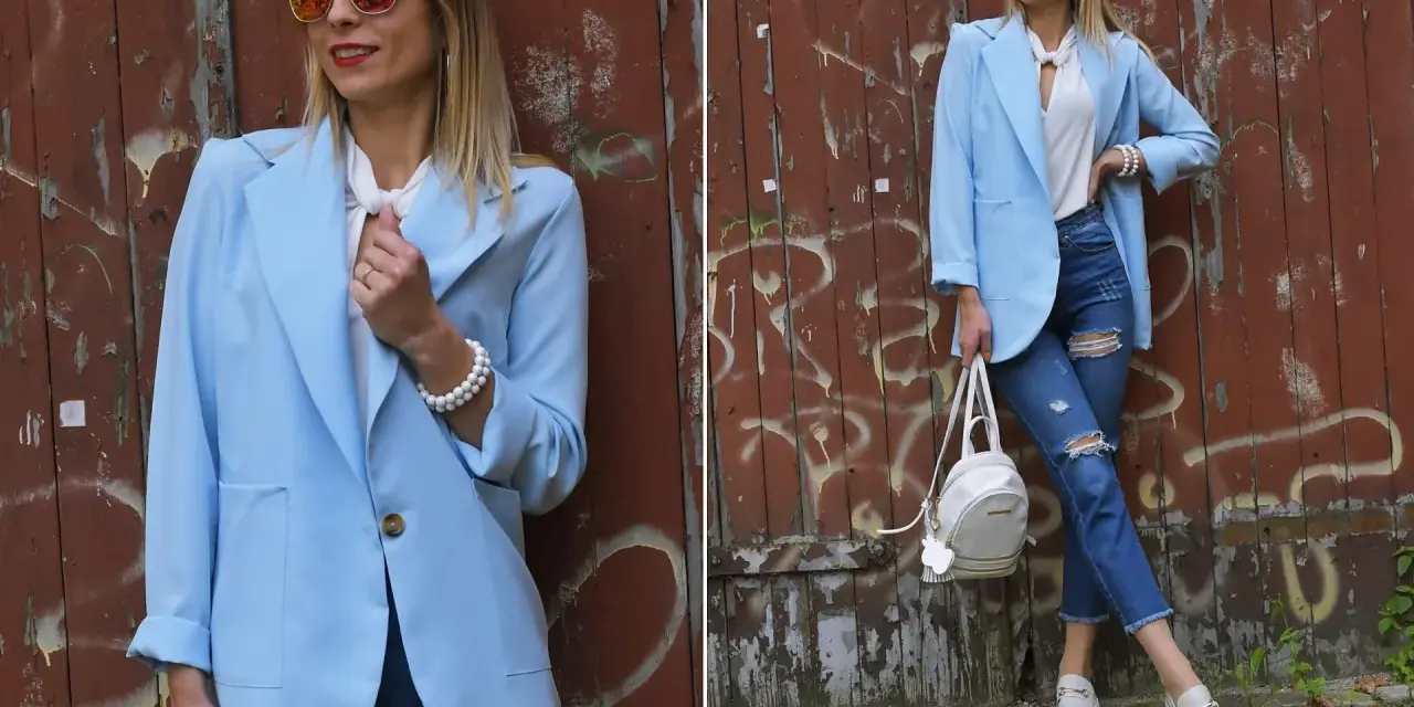 Kobieta w błękitnej marynarce i podartych jeansach prezentuje stylowe stylizacje. Okulary przeciwsłoneczne dodają charakteru.