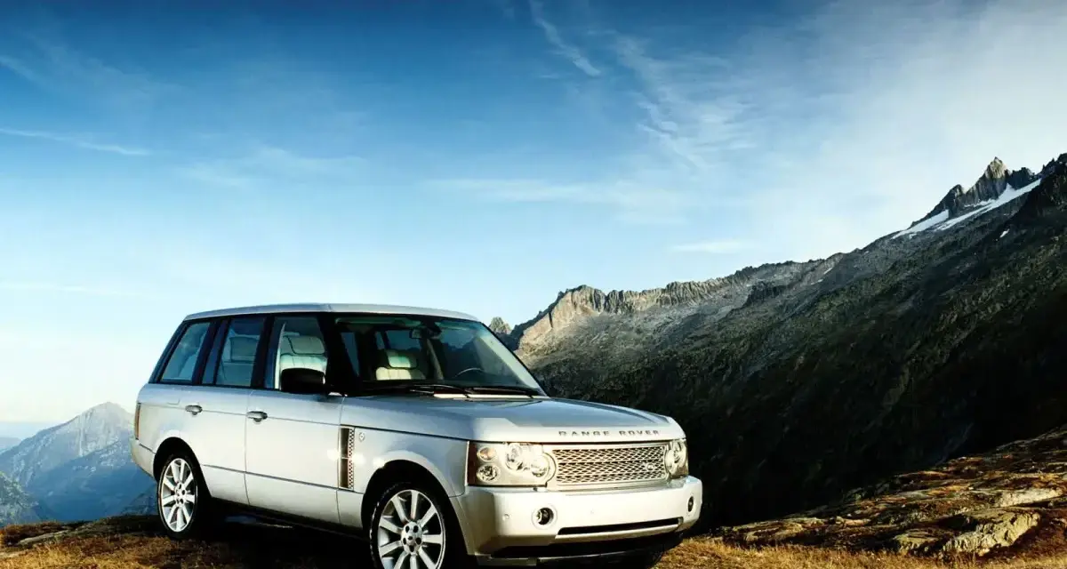 Srebrny Range Rover Vogue na tle górskich szczytów. Gotowy na każdą przygodę.