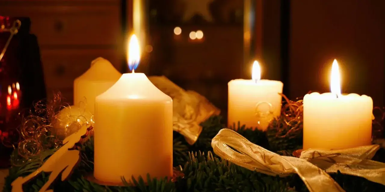Vier Kerzen auf einem Adventskranz brennen. Der erste Advent ist da und die Vorfreude auf Weihnachten steigt.