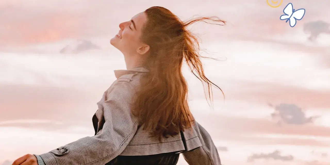 Embracing the sky, a woman with flowing red hair embodies joy, a feeling achievable through 7 daily habits. A butterfly and smiley faces float above.