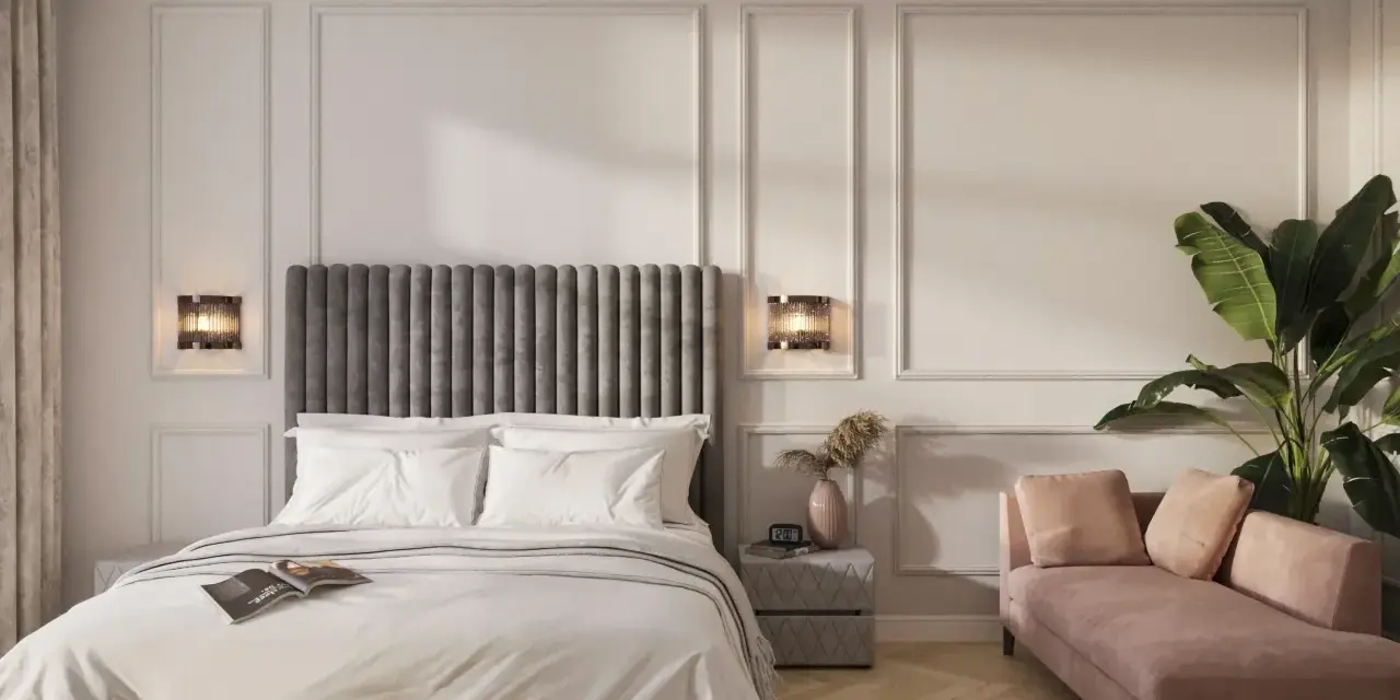 Elegancka sypialnia z łóżkiem, różową sofą i rośliną.
