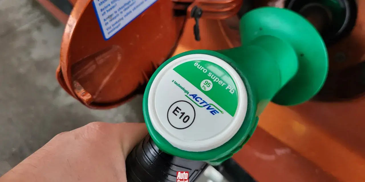 Dłoń trzyma zielony pistolet dystrybutora paliwa z napisem "euro super Pb 95 ACTIVE E10". To paliwo E5, które właśnie tankujesz.