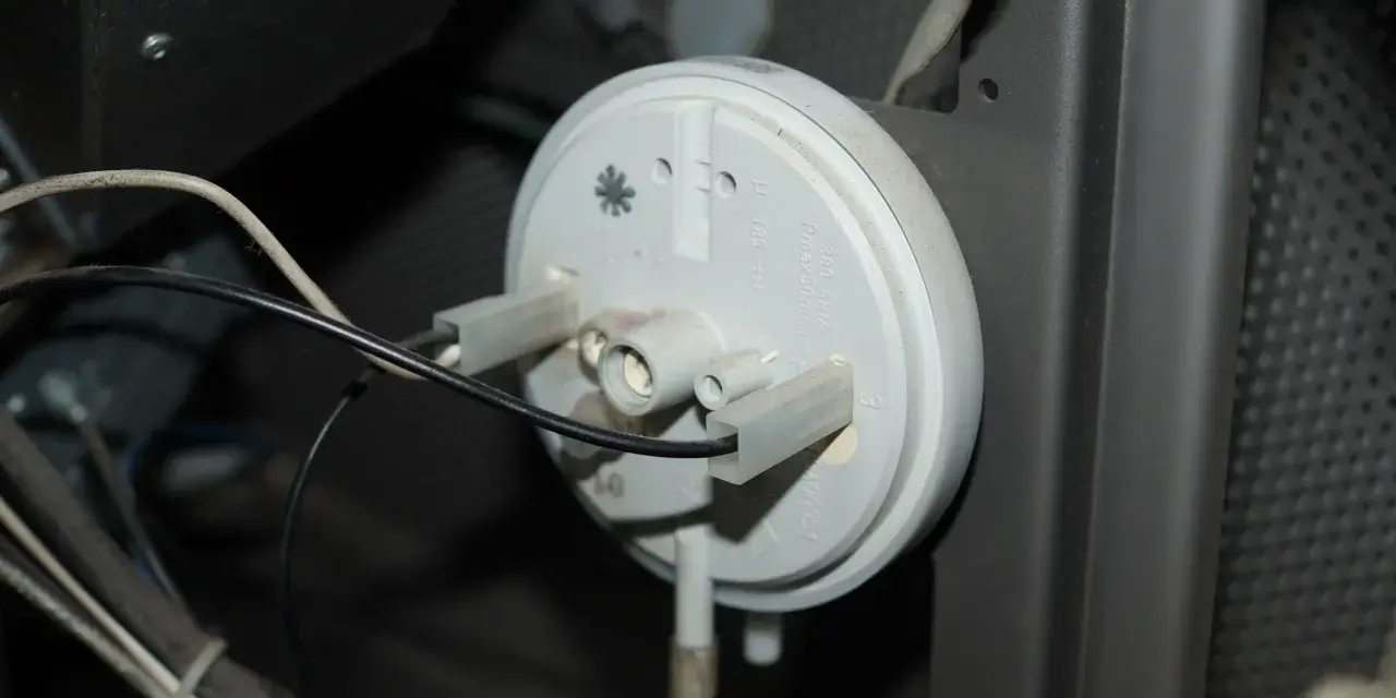 Componente di una stufa pellet King, forse la causa di problemi. Si vede un pressostato con cavi collegati.
