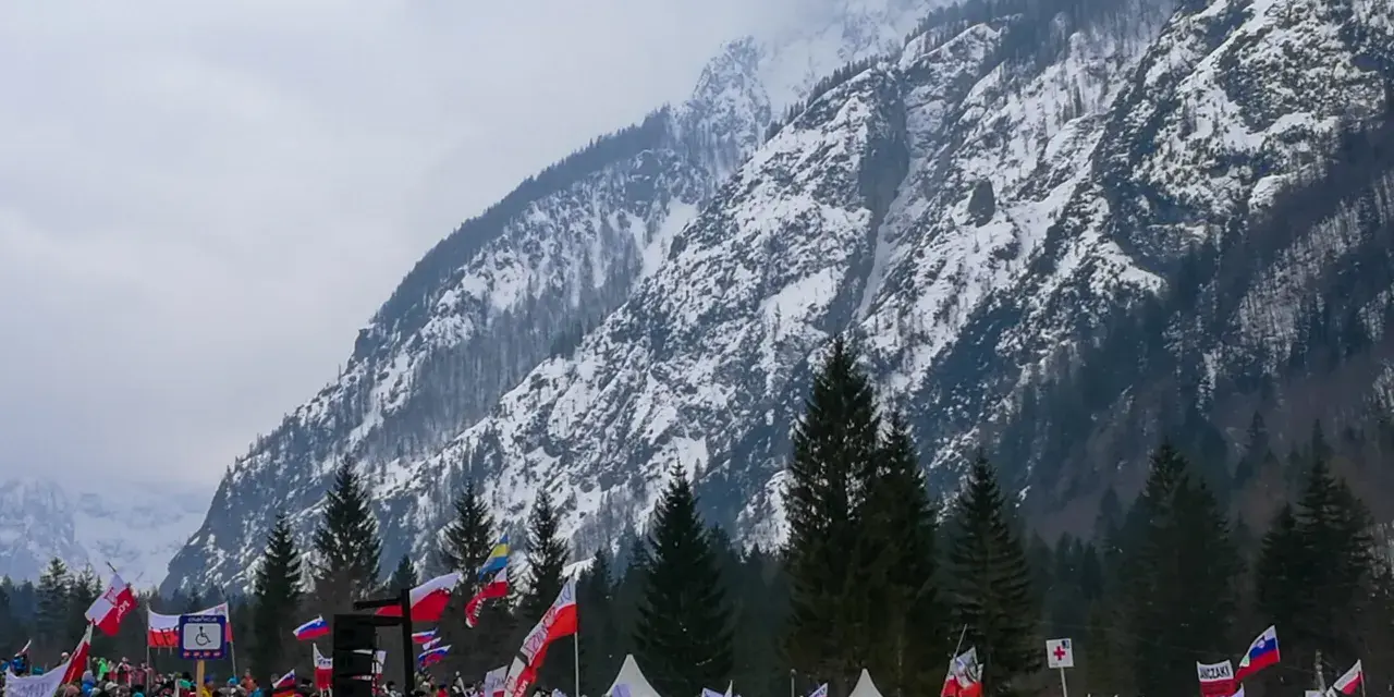 Tłum kibiców z flagami w słoweńskiej Planicy, gdzie znajduje się słynna skocznia narciarska.