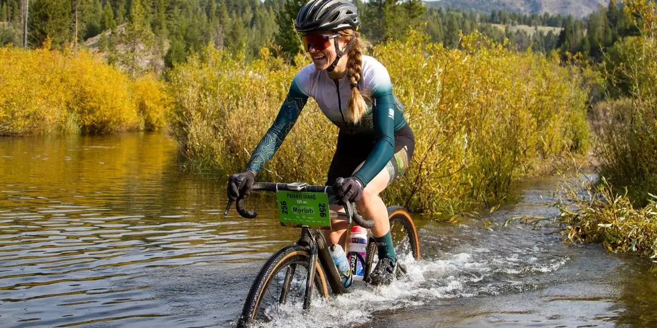 Moriah Wilson splashes through a river on her bike, a challenging part of the race. Kaitlin Armstrong might have faced similar obstacles.