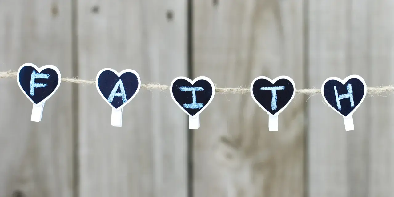 Five heart-shaped clothespins spell "FAITH" on a string, a reminder for prayers for children.