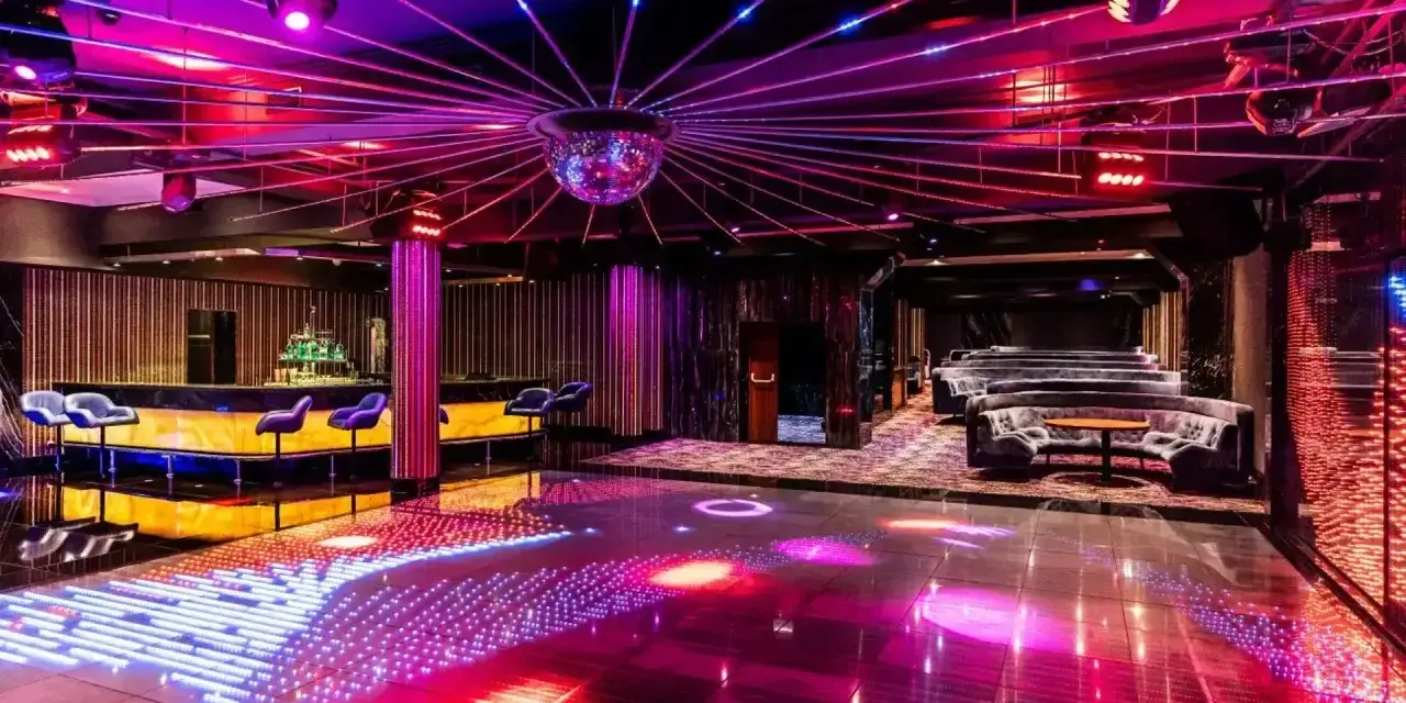 Nowoczesny klub z podświetlaną podłogą i barem, idealny na sylwester w Hotelu Gołębiewski.