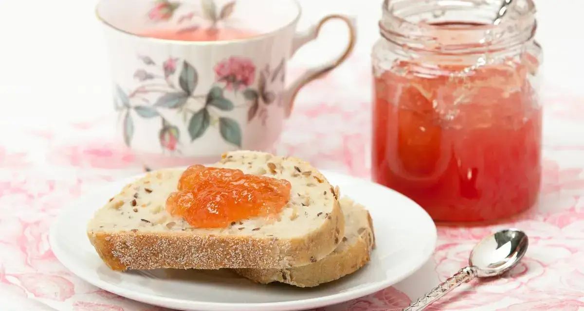 Fetta di pane con marmellata di anguria, tazza da tè fiorita e barattolo di marmellata.