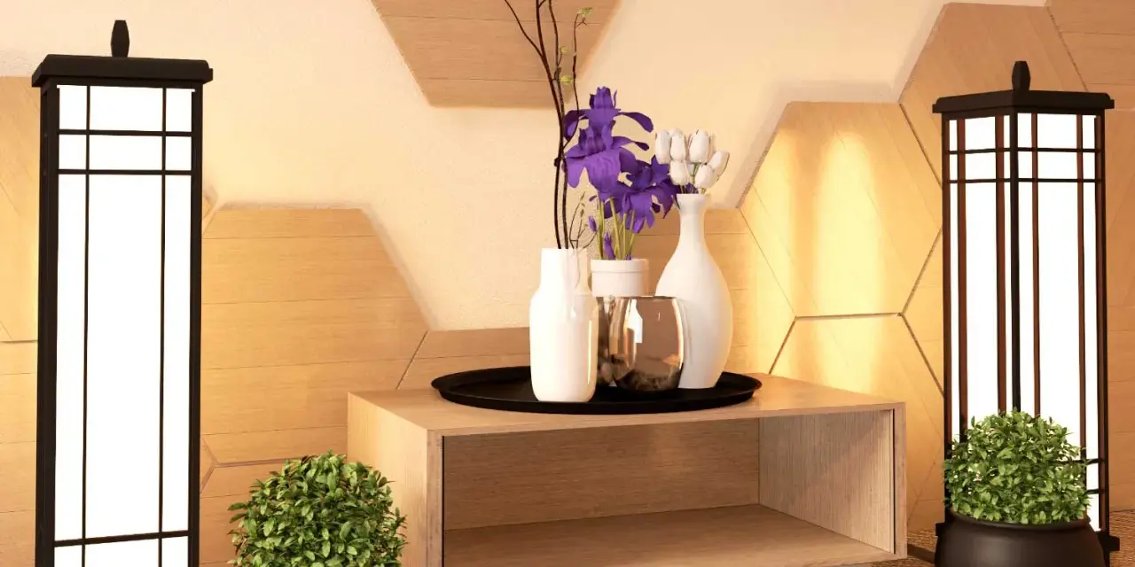 Ideas para como adornar una mesa de salon: dos lámparas, plantas, jarrones con flores y un detalle metálico sobre un mueble de madera.