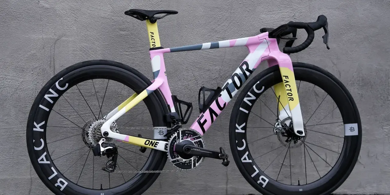 A stylish pink, yellow, and grey Factor road bike, perfect for women beginners looking for a fun and fast ride.