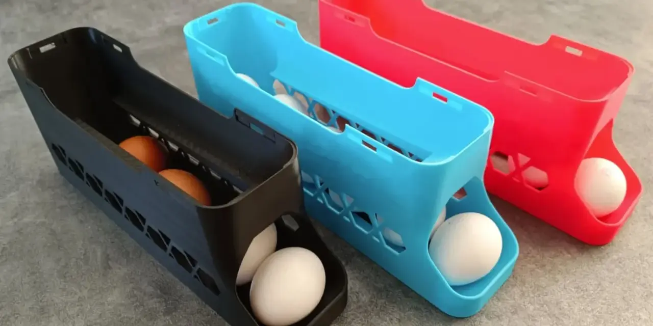 3D printed egg holders in black, blue, and red. See what you can do with a 3d printer: create practical kitchen organizers!