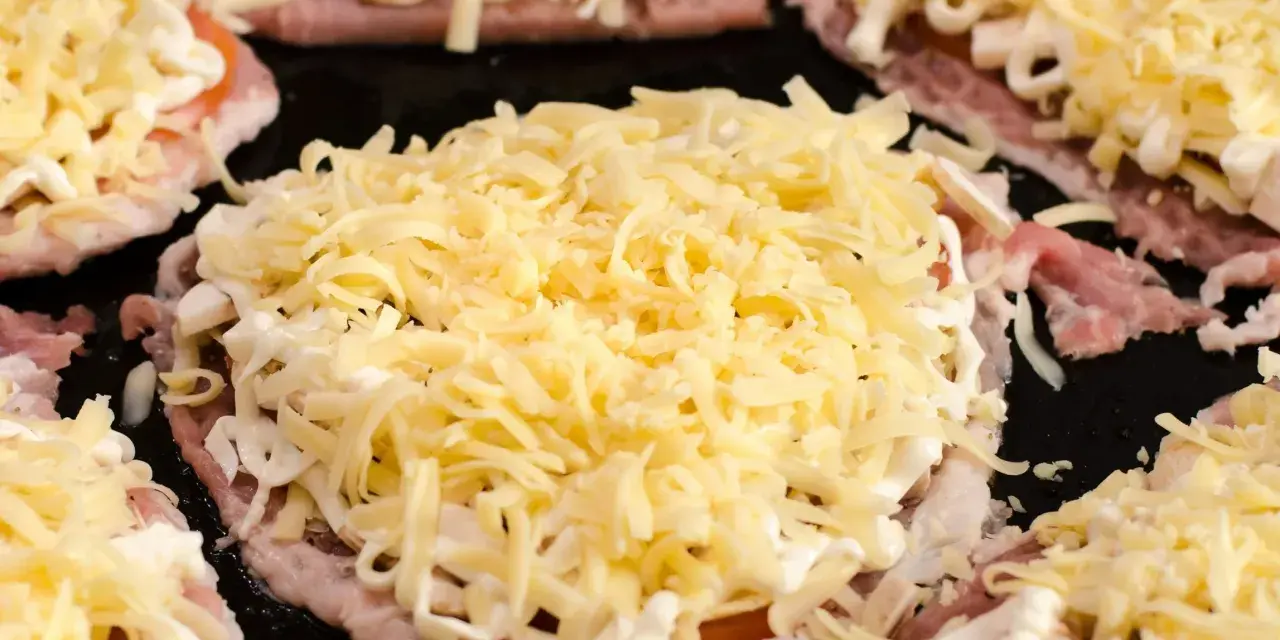 Plastry schabu z pieczarkami i serem, gotowe do zapieczenia. Idealny pomysł, co zrobić ze schabu w plastrach na szybki obiad.