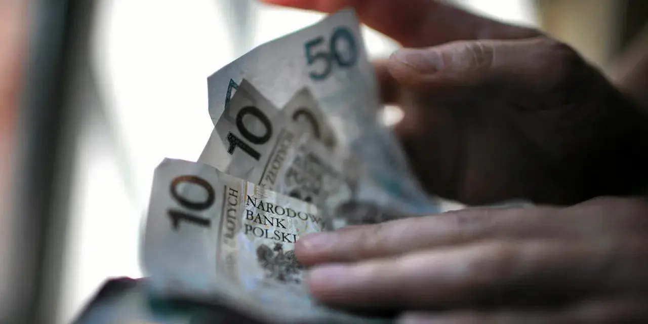 Dłonie trzymają polskie banknoty 10 i 50 zł. Czy na bierzmowanie daje się prezenty? Pieniądze mogą być odpowiedzią.
