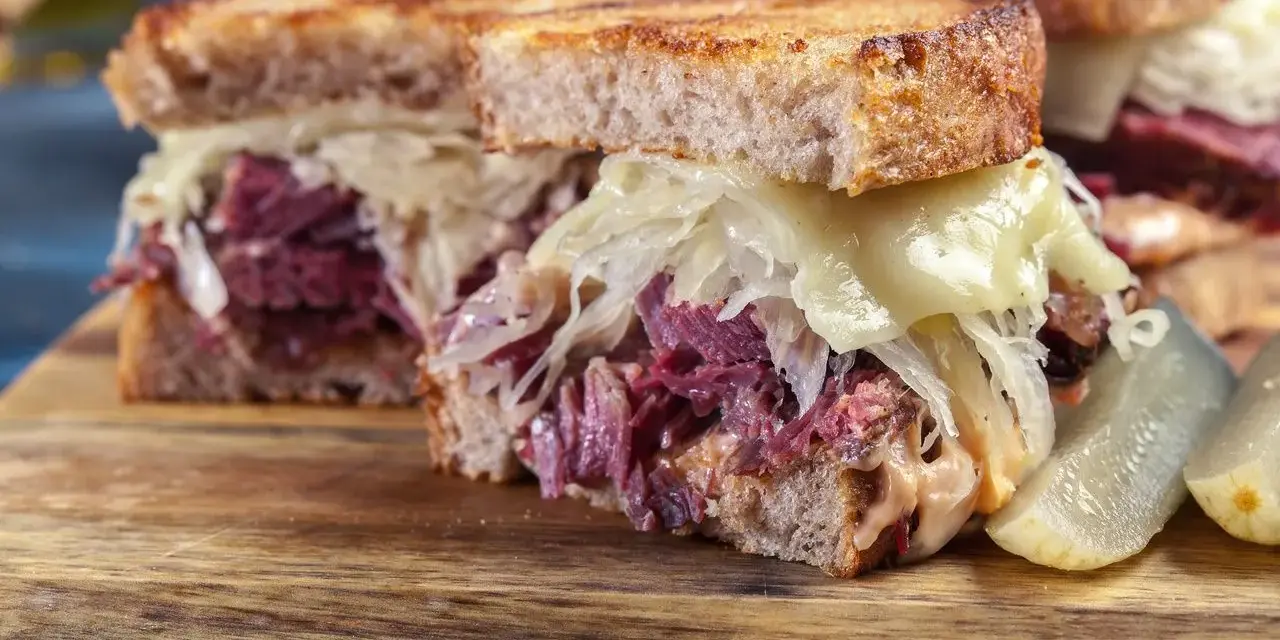 Kanapka z pastrami, kiszoną kapustą i serem. Tak wygląda pyszne pastrami co to jest, czyli wołowina w przyprawach.