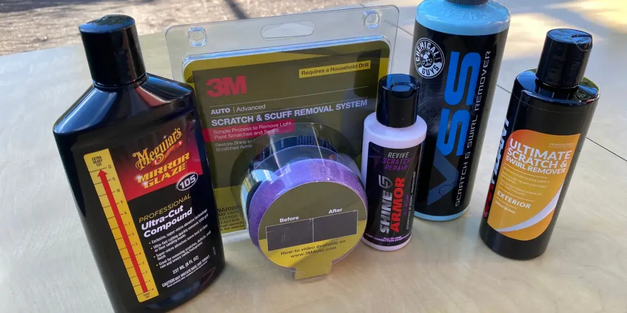 Car scratch removal products, including rubbing compound, are laid out, ready to tackle paint scratches and swirls.