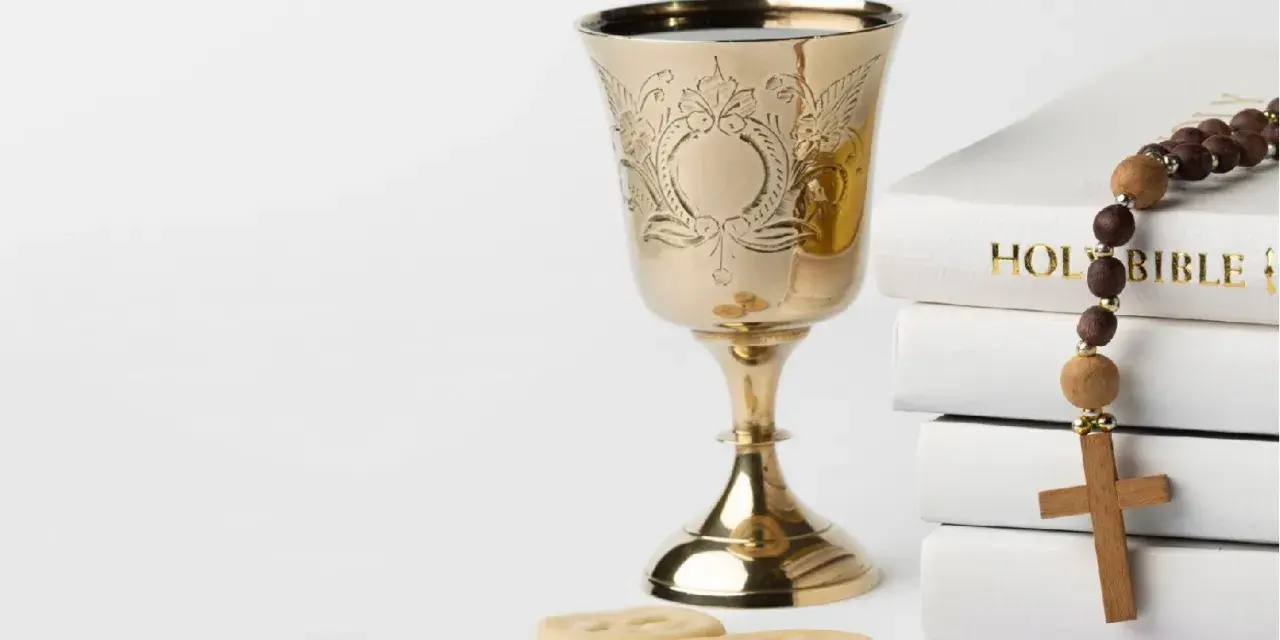 Złoty kielich, hostie, różaniec i Biblia. Symbolika sakramentu, który może być odnotowany w akcie chrztu.