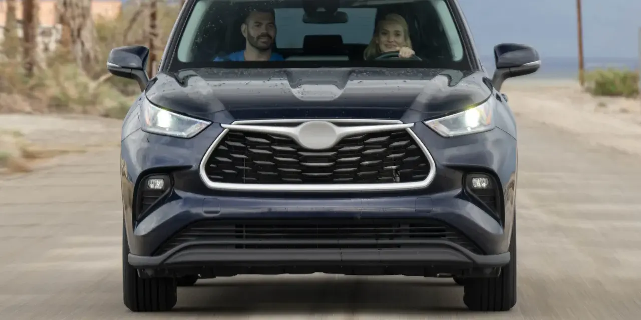A couple in a dark SUV drive on a dirt road. They might be wondering how long to wait for jump start if the car dies.