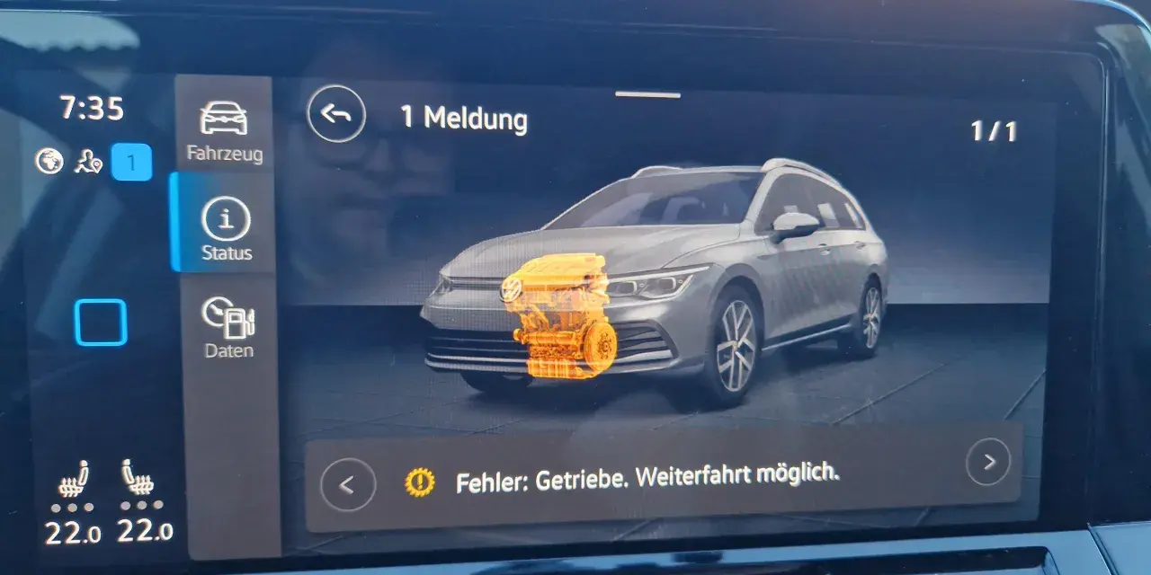 Golf 8 Probleme: Warnmeldung "Fehler: Getriebe. Weiterfahrt möglich." auf dem Display. Ein orangefarbener Motor ist abgebildet.