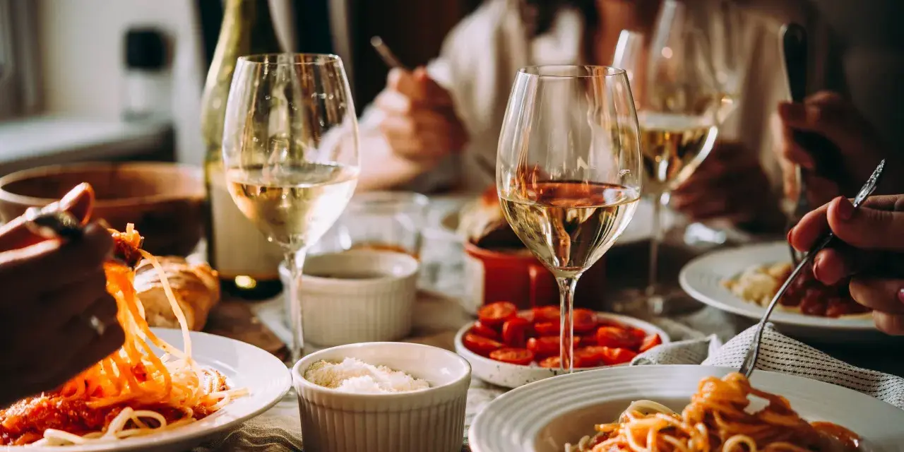 En härlig middag med pasta och tomatsås, ackompanjerad av ett glas vitt vin.