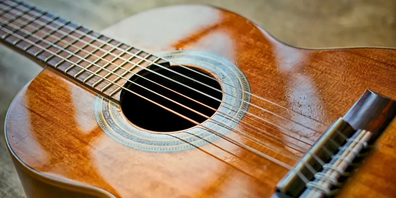 Klasyczna gitara, gotowa do wykonania znanych utworów na gitarę klasyczną. Jej drewniane, lśniące pudło rezonansowe zaprasza do muzycznej podróży.